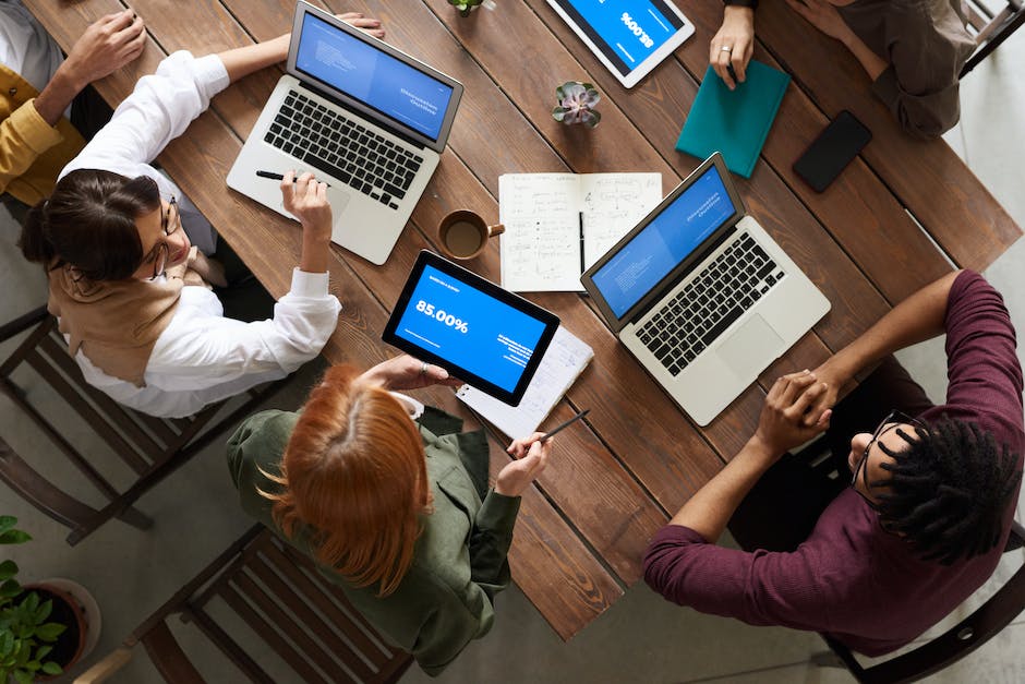 Augmenting Academics: The Role of Technology in Education 4 A group of students using laptops and tablets, engaged in technology-enabled learning